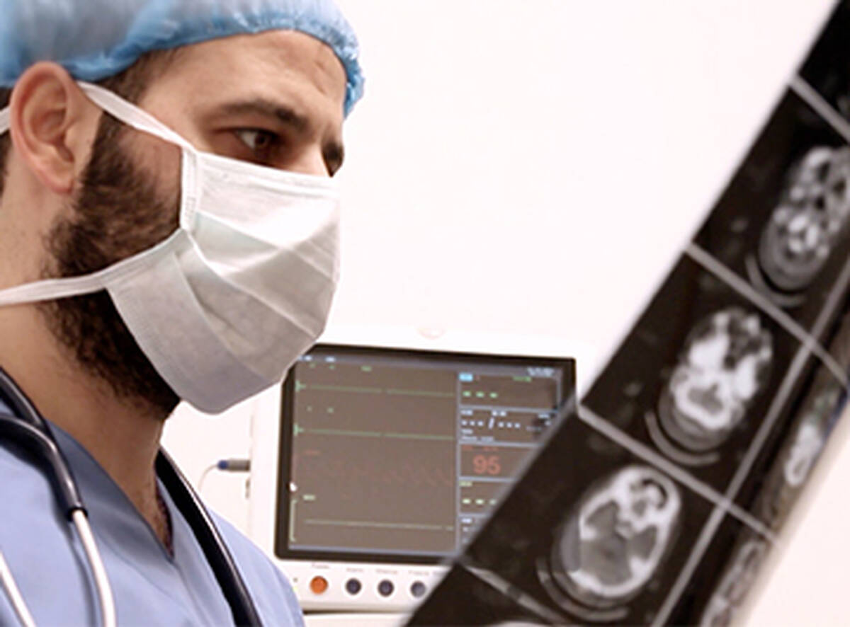 A doctor examines a brain scan.