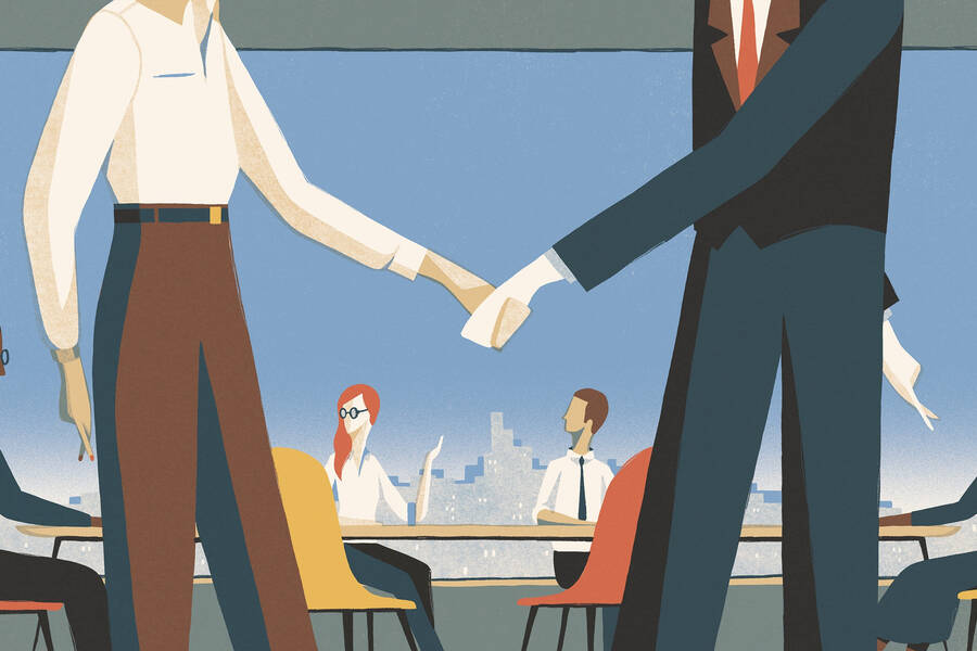 A woman shakes a man's hand.