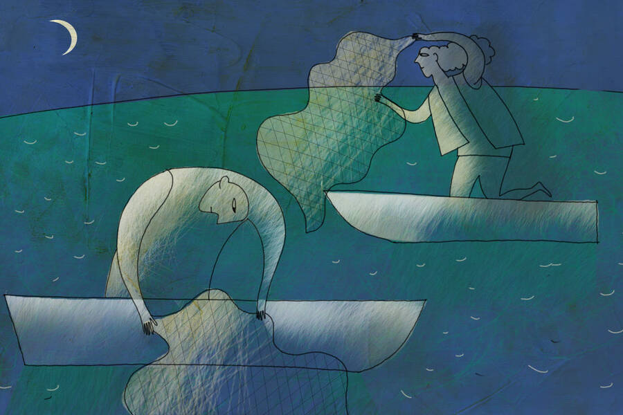 A man and a women cast nets into the water.