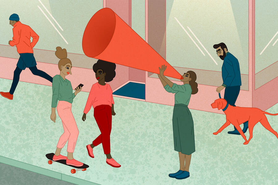 A woman on a street talks through a large megaphone.