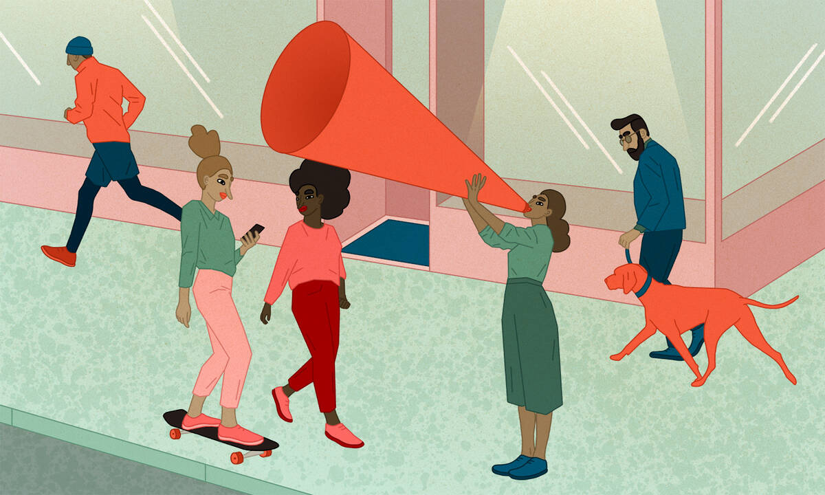 A woman on a street talks through a large megaphone.