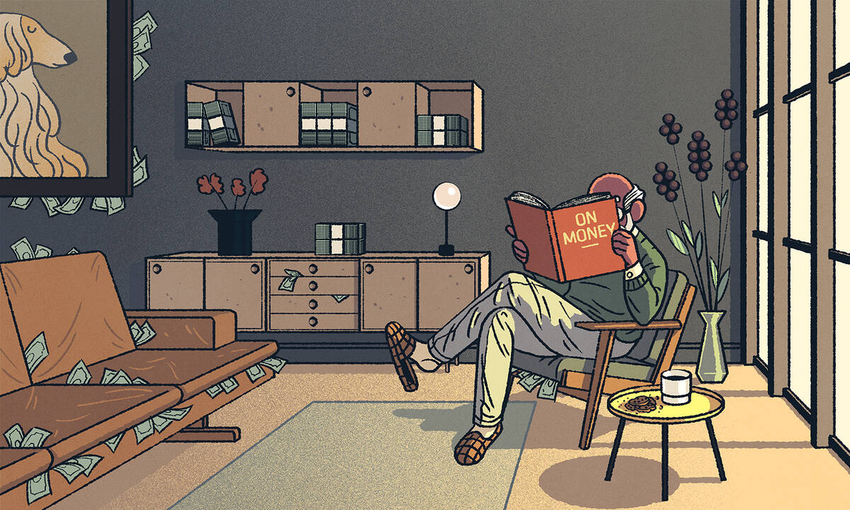 Man reading financial literacy book in living room.