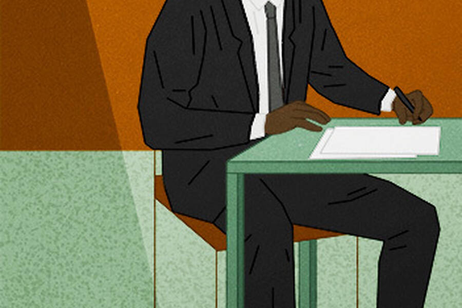Babyfaced CEO seated at table