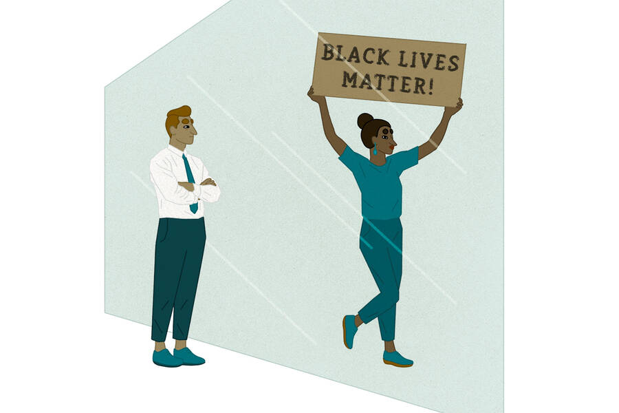 Black Lives Matter protester walks past business