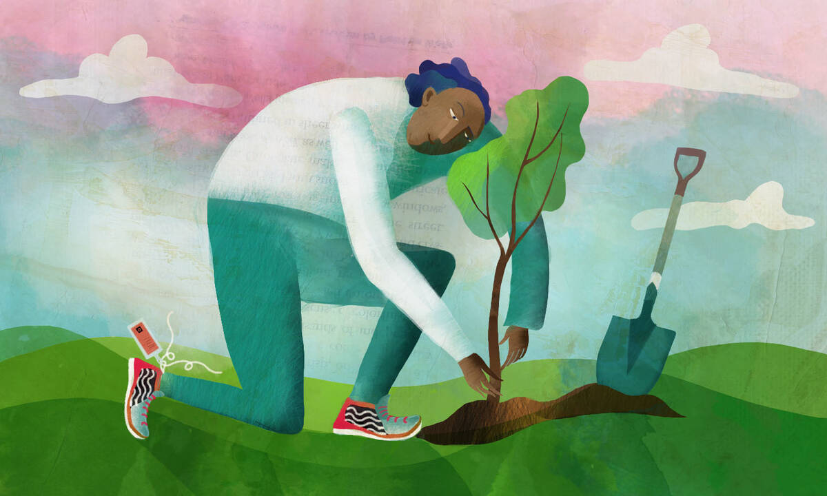 person in new sneakers plants tree