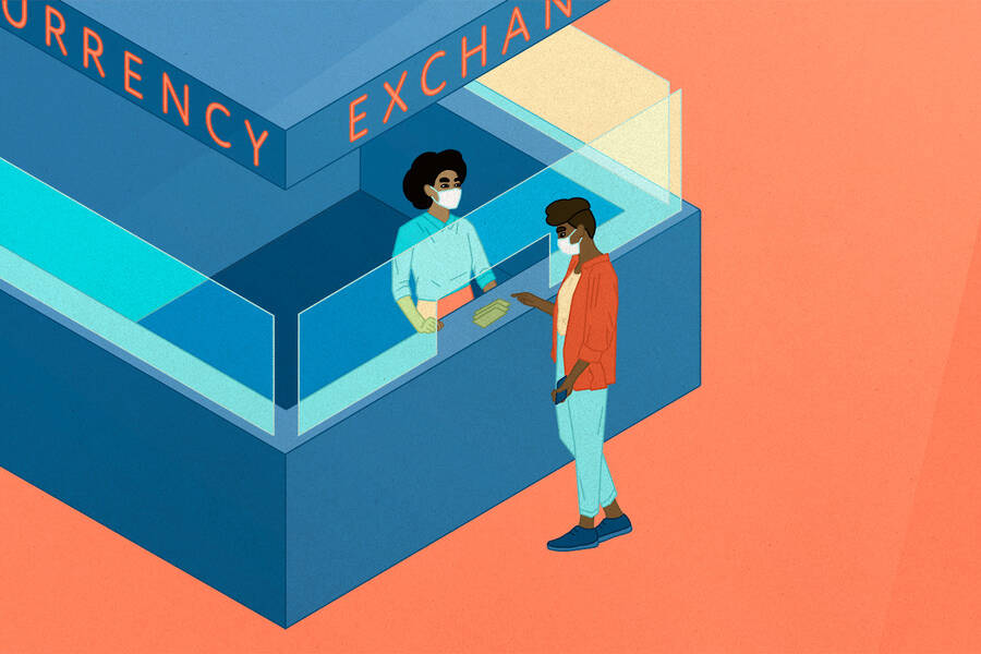 person changing currency at currency exchange kiosk