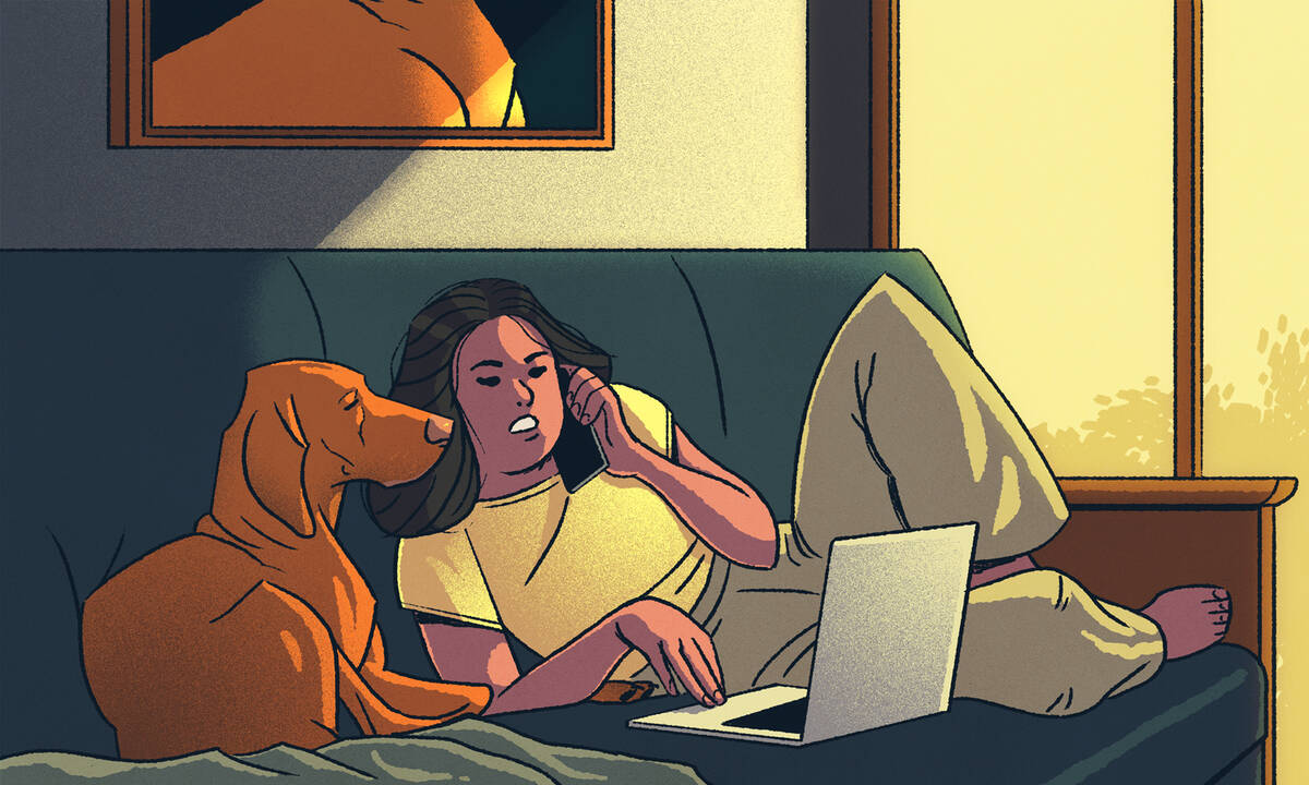 woman working from home couch with dog