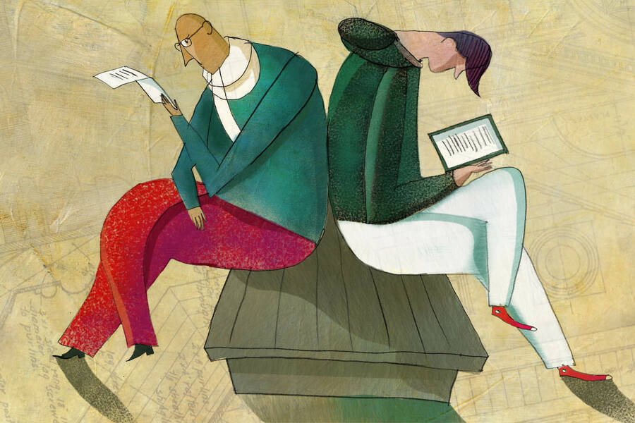 two people sitting back to back, one reading a digital tablet and the other a paper flyer.