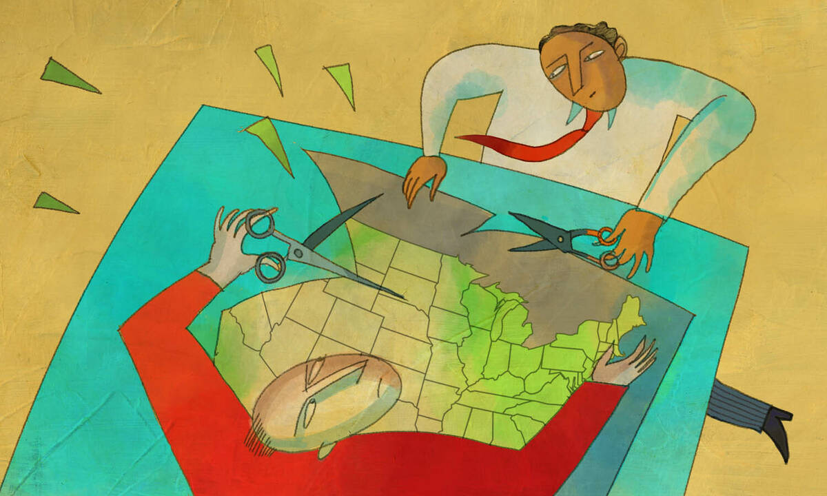 two people cut a U.S. map with scissors