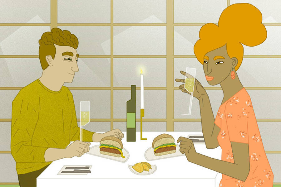 A couple maintains self-control while eating.