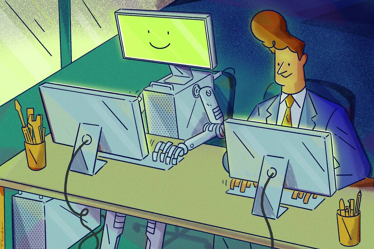 person working on computer next to computer working at a computer