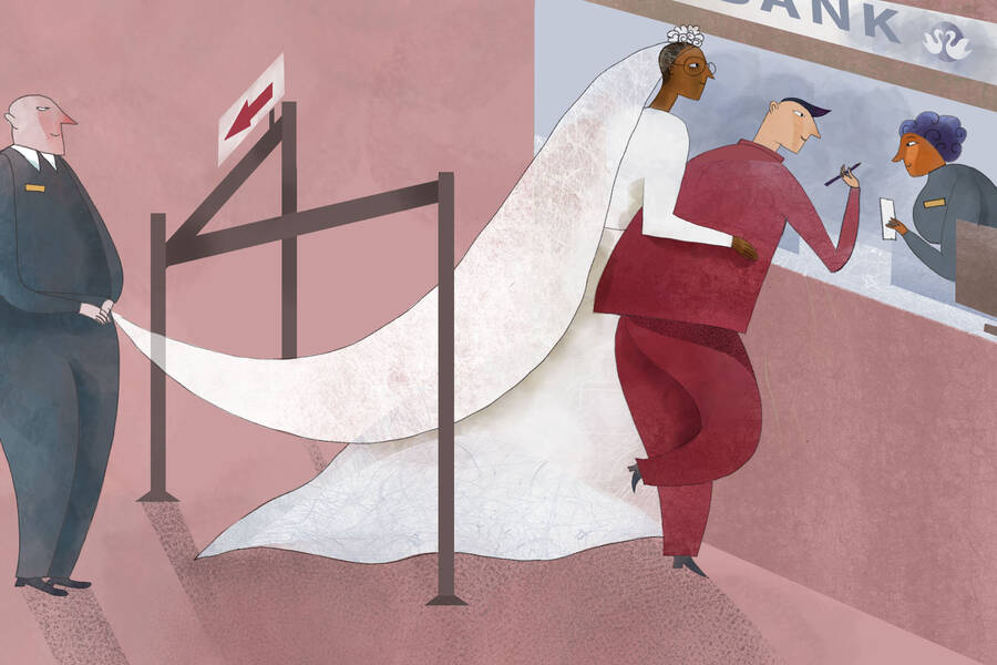 married couple standing at bank teller's window
