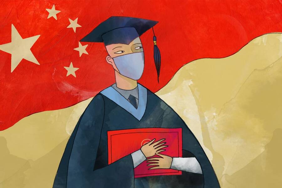 college graduate standing before Chinese flag