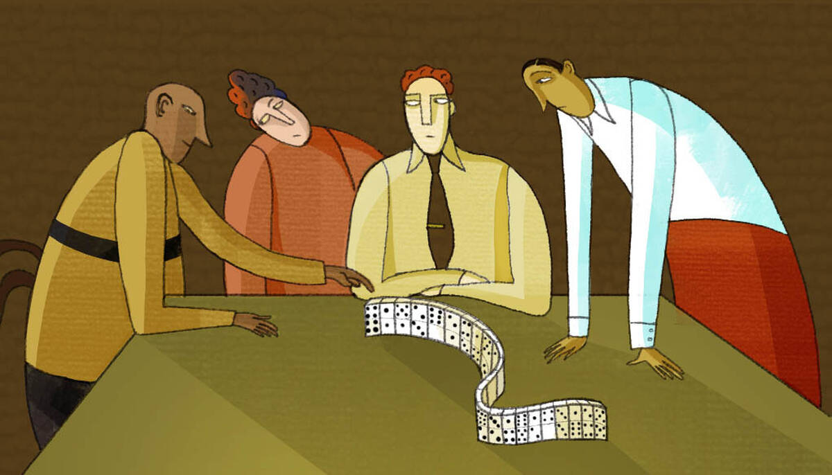 four people at a table with a domino game
