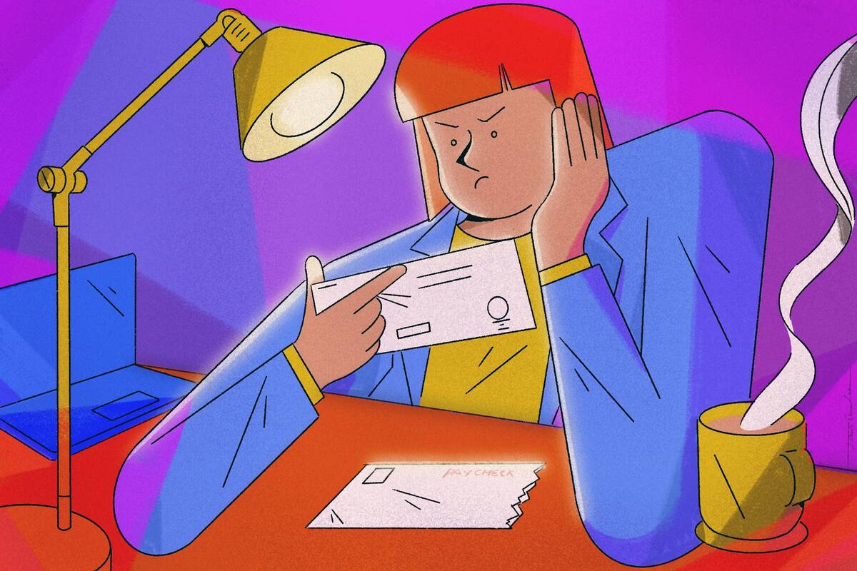 younger employee looking disappointedly at paycheck.