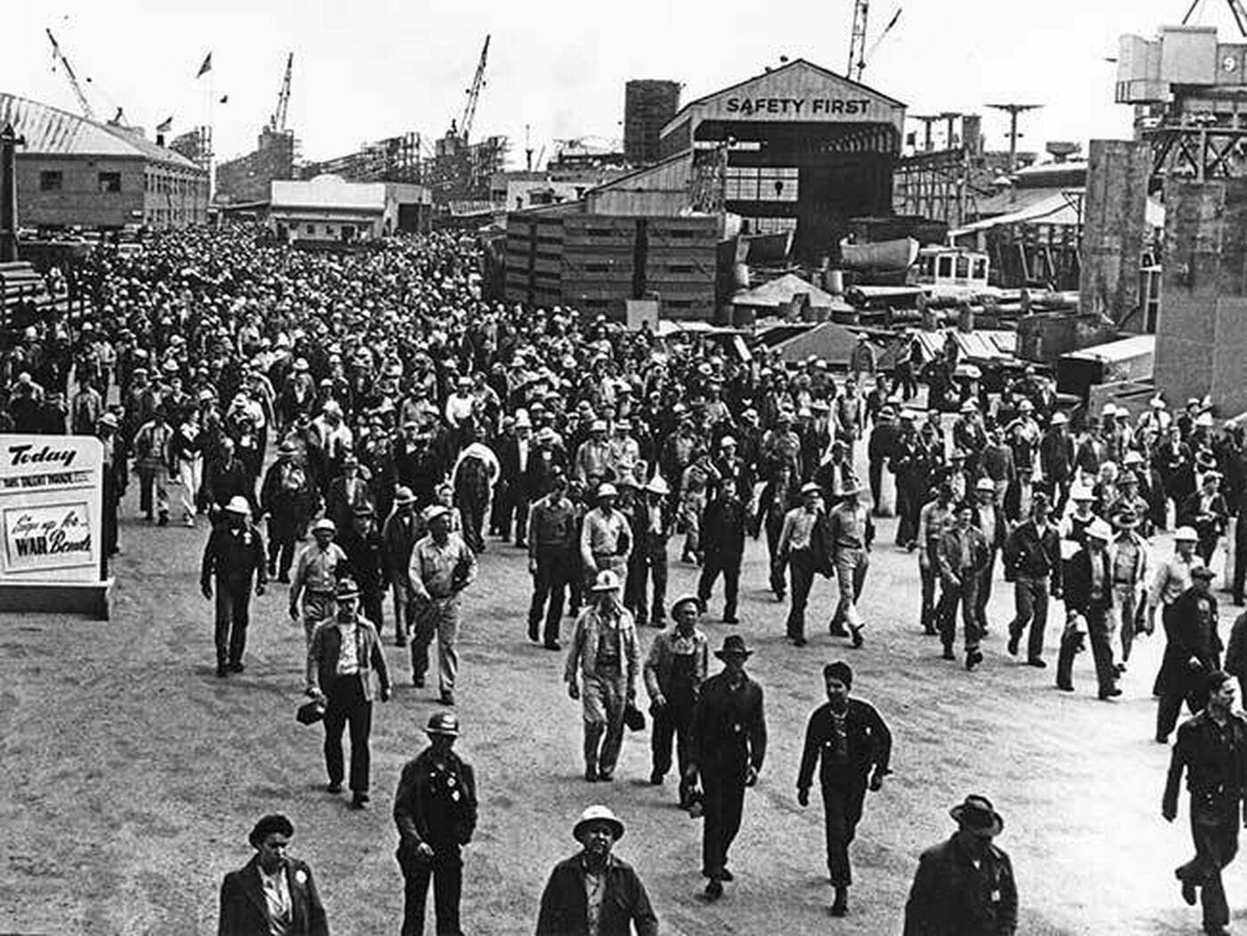 shipyard workers walking away from factory after shift