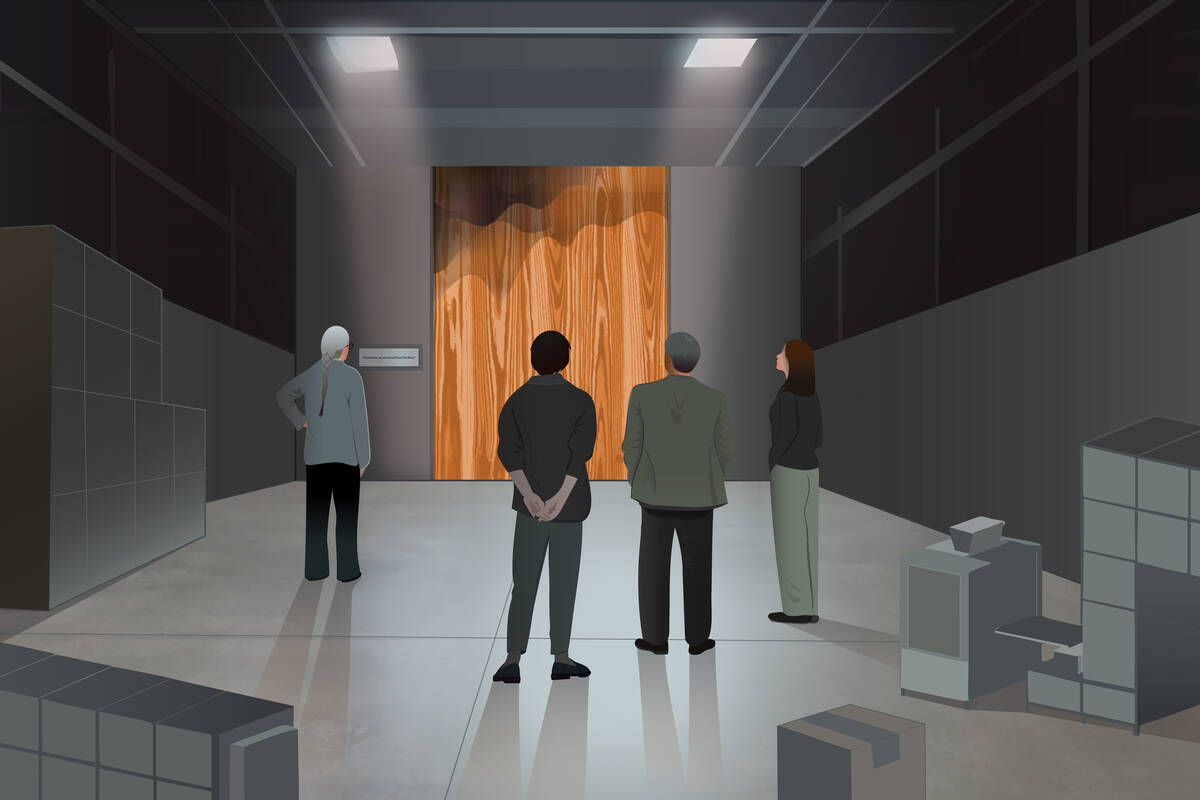 group of employees stand on a shop floor looking at a weathered wood panel from the factory.