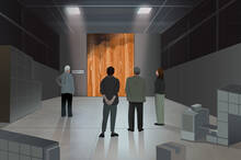 group of employees stand on a shop floor looking at a weathered wood panel from the factory.
