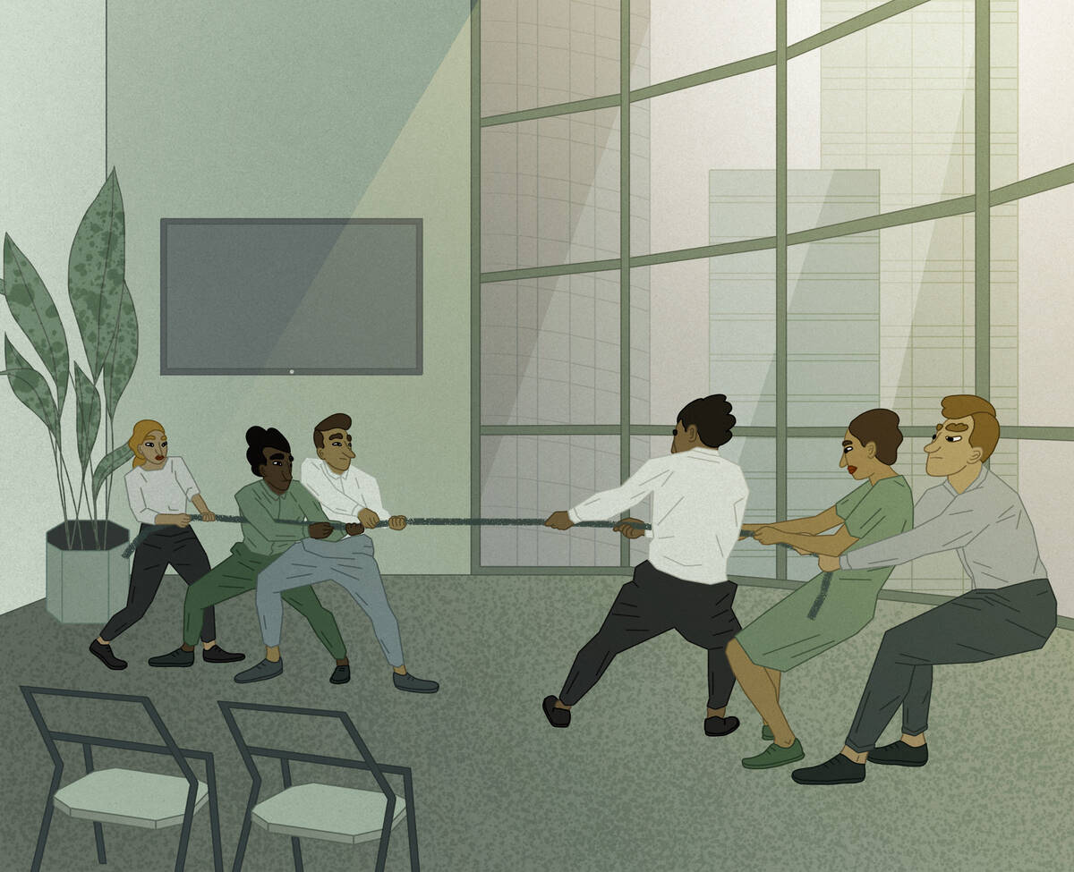 Two office teams have a tug-of-war in a conference room