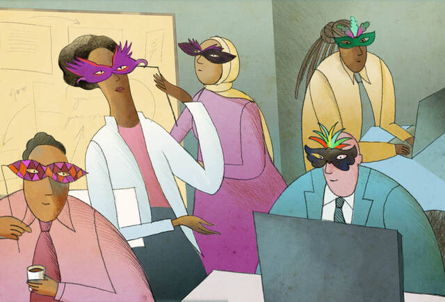 group of employees wearing mardi gras masks in office.